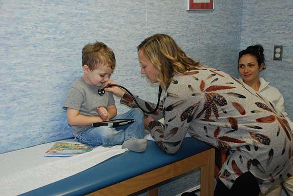 little boy being checked by doctor